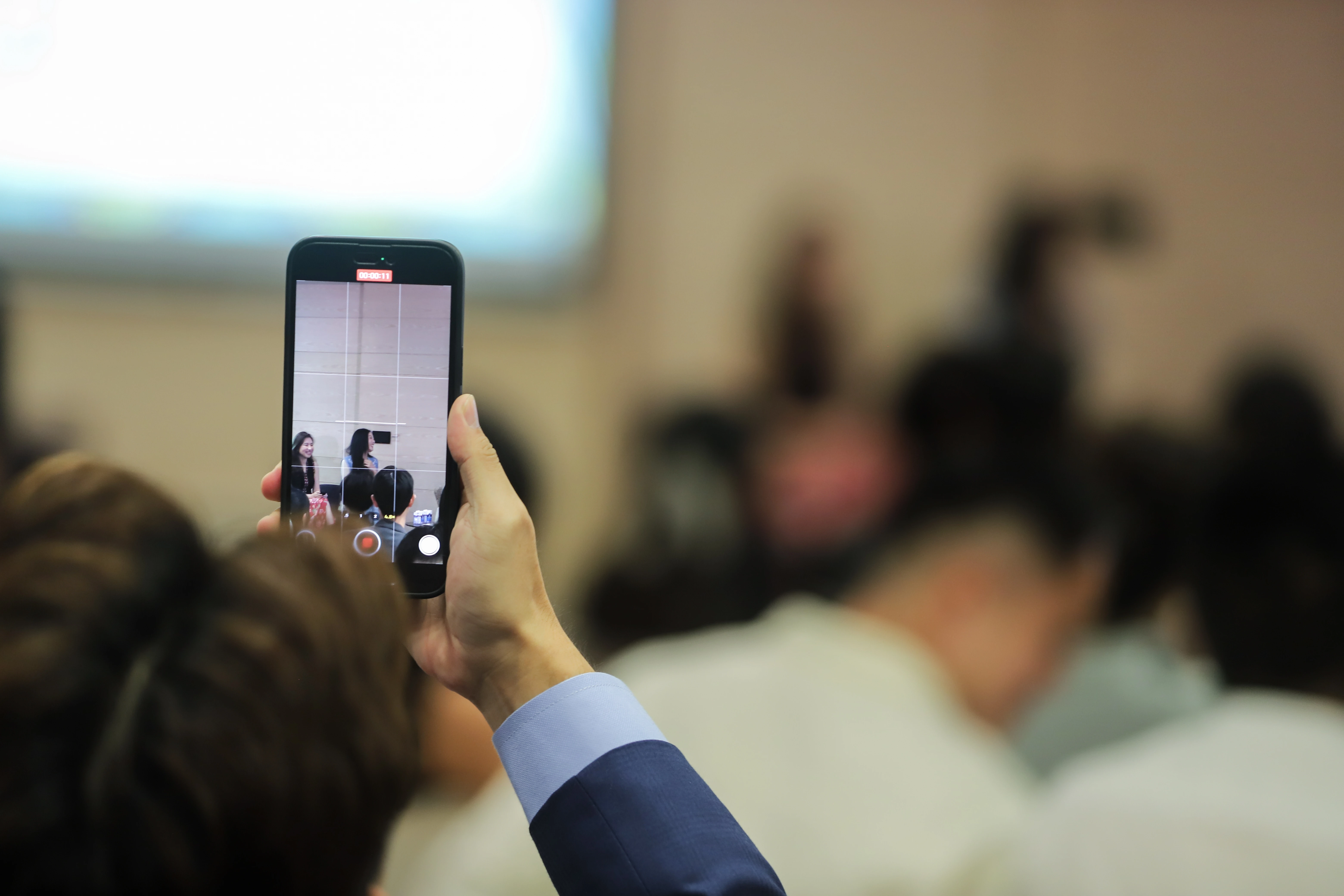 Event audience holding smartphones to record stage activity