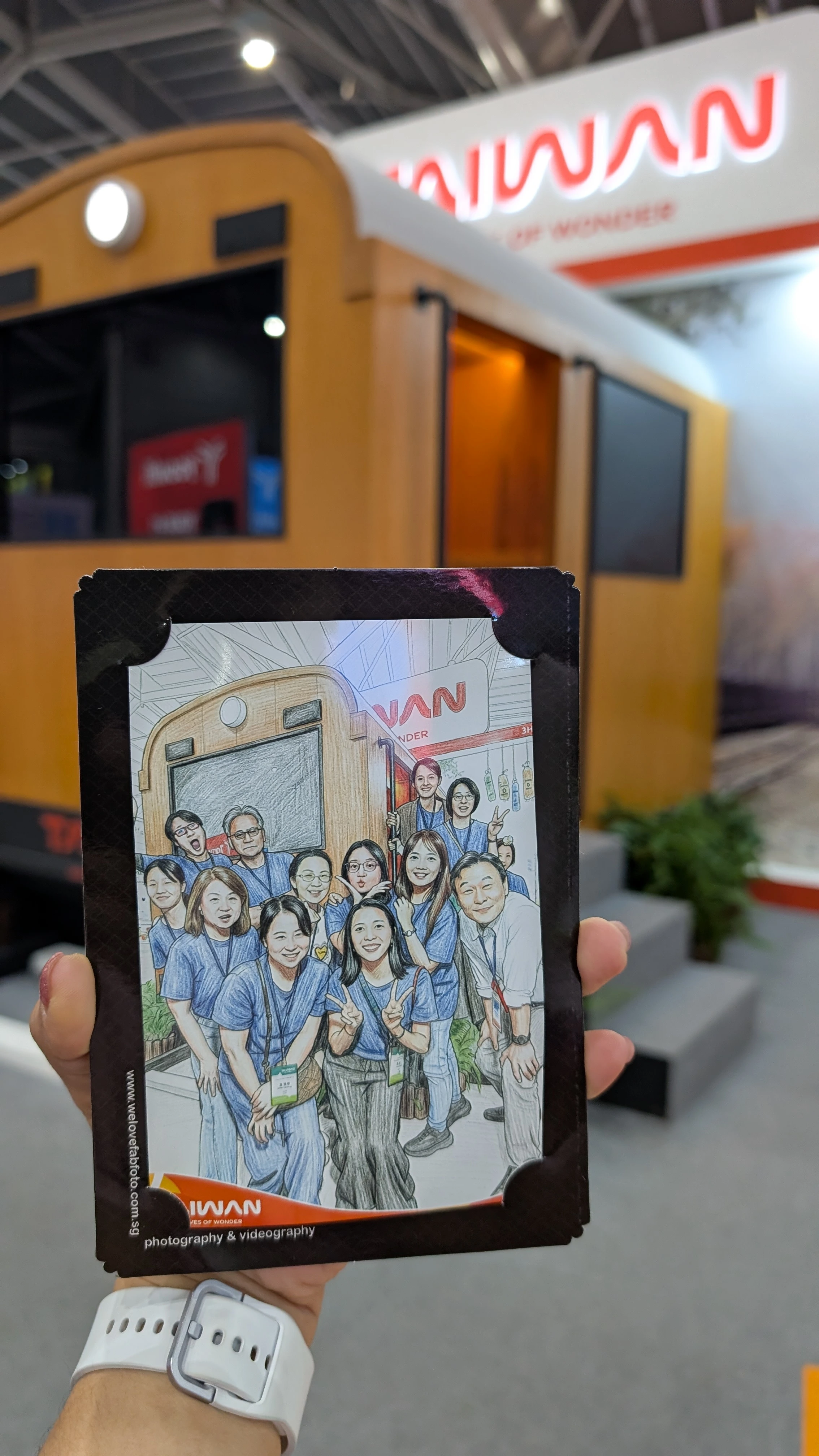 AI photo booth sketch printout held in hand in front of event booth