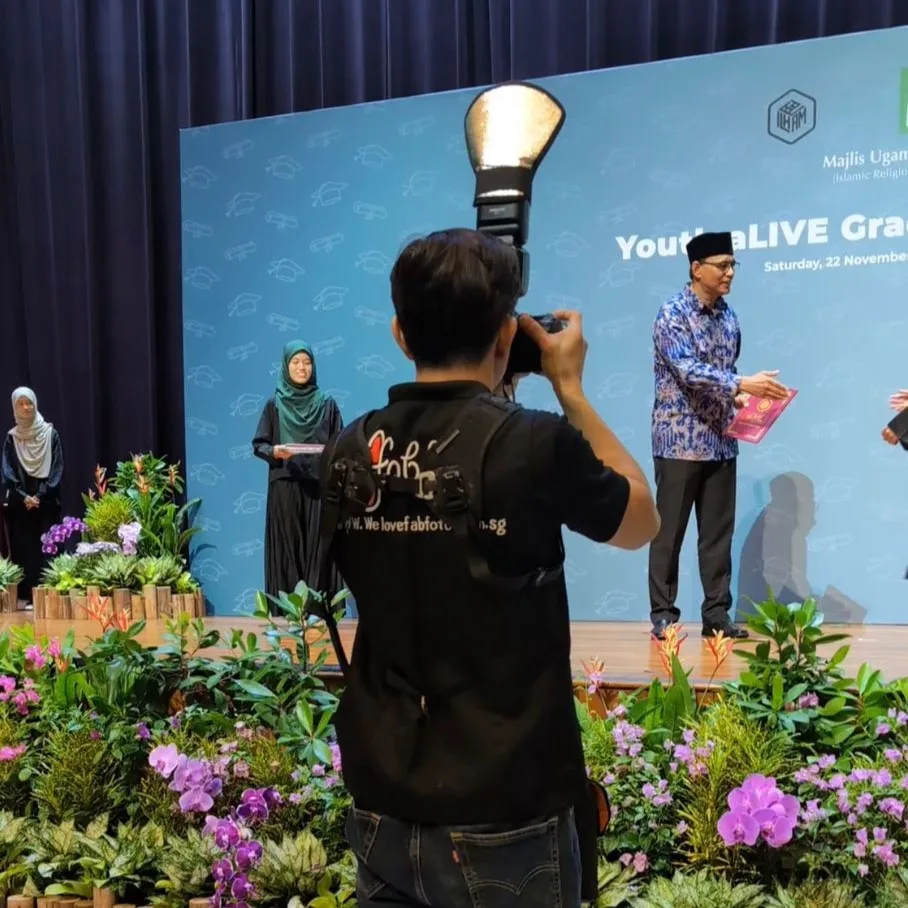 Professional event photographer capturing live stage awards and presentations