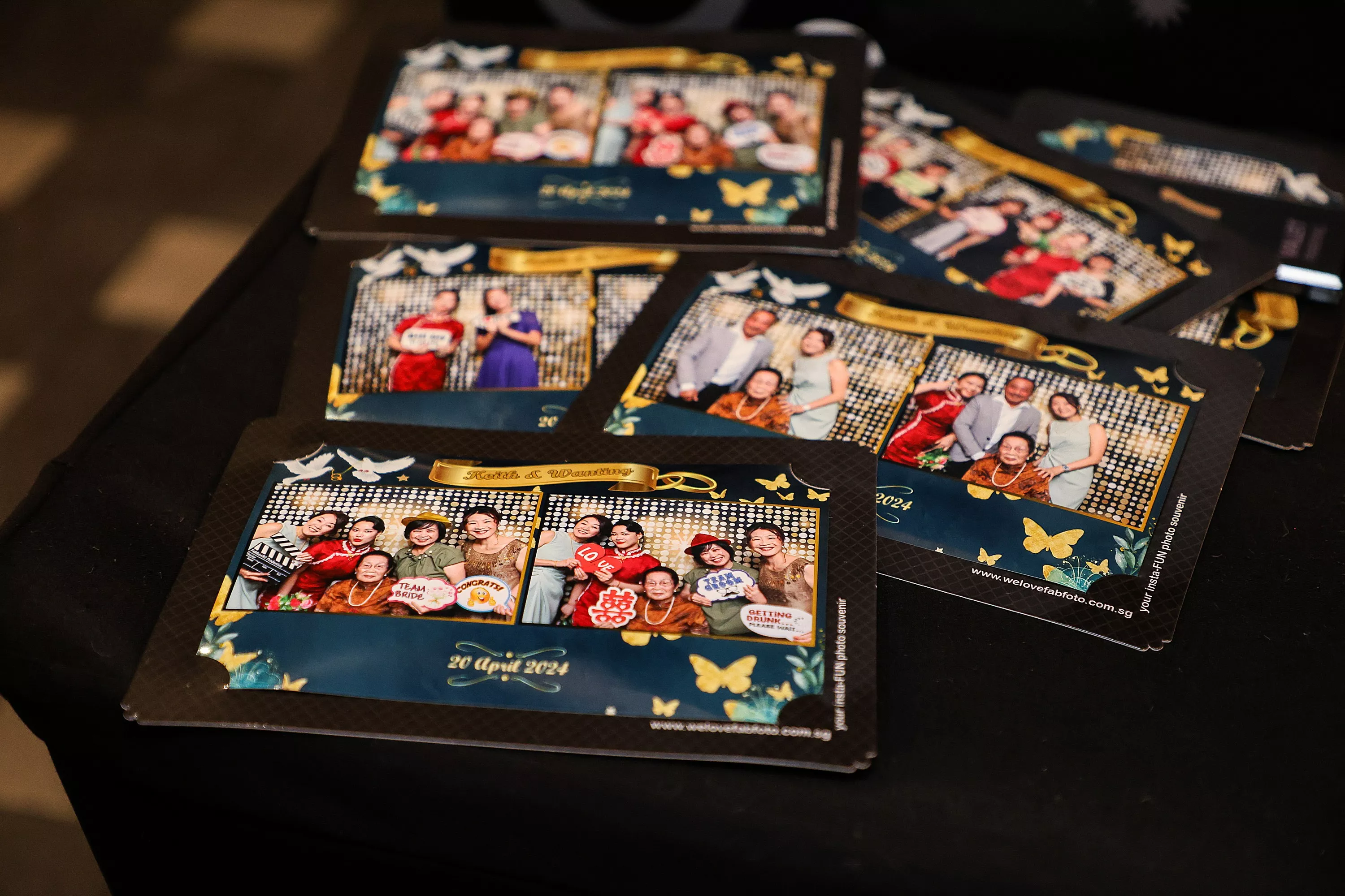 Printed wedding photo strips from a photobooth displayed on table