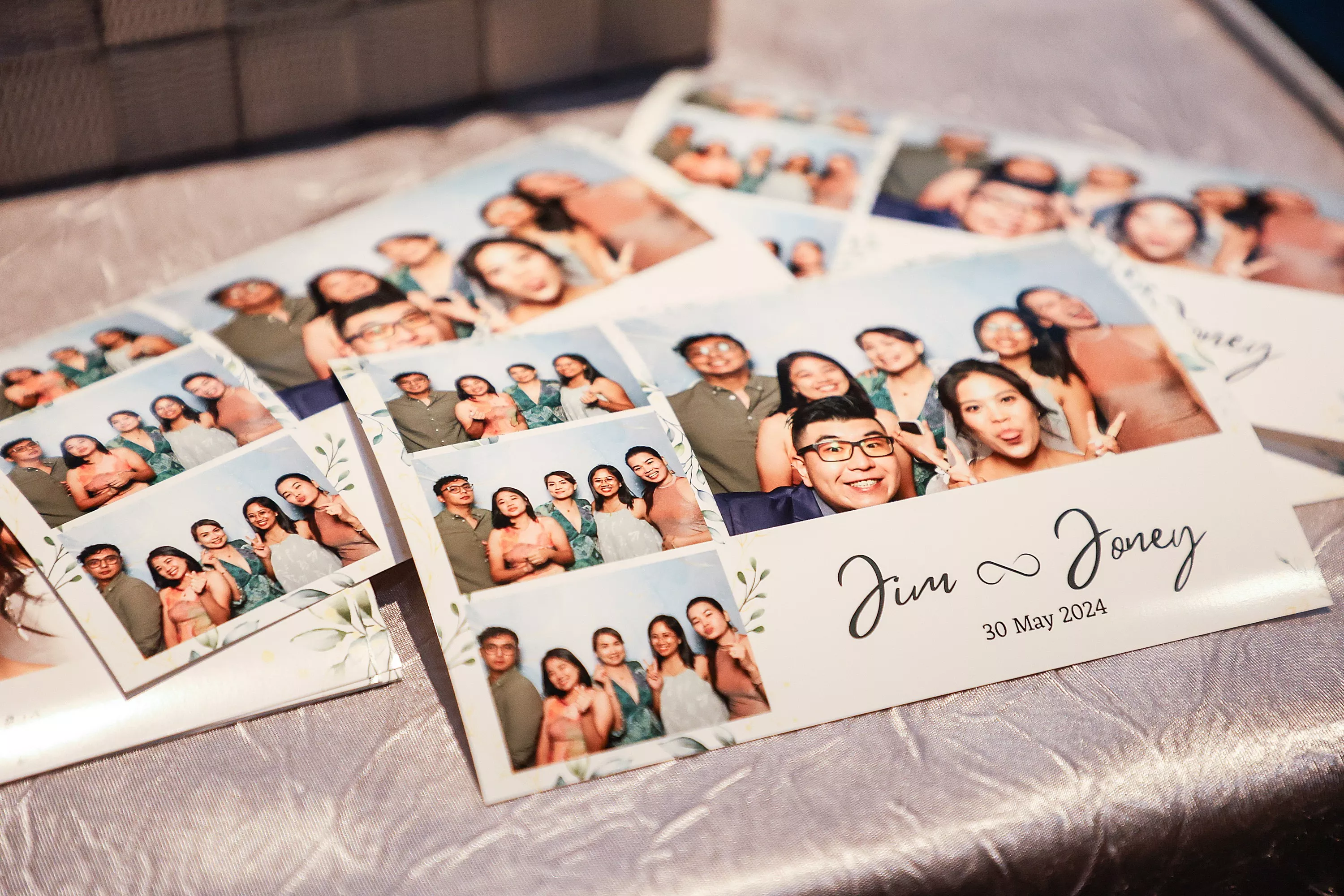 Smiling bride and groom posing with guests in a wedding photo booth