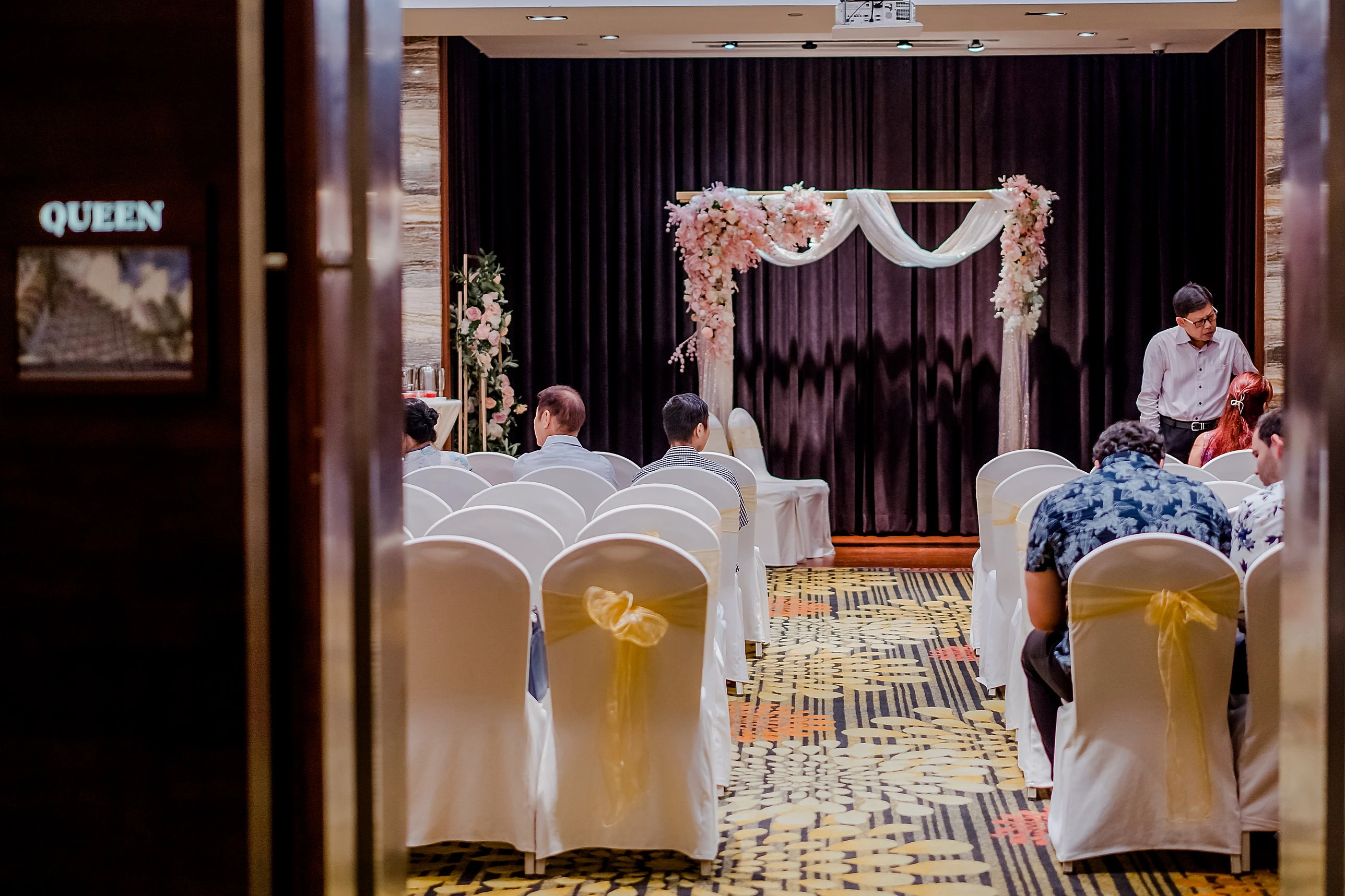 Elegantly decorated wedding venue solemnization setup with floral arch