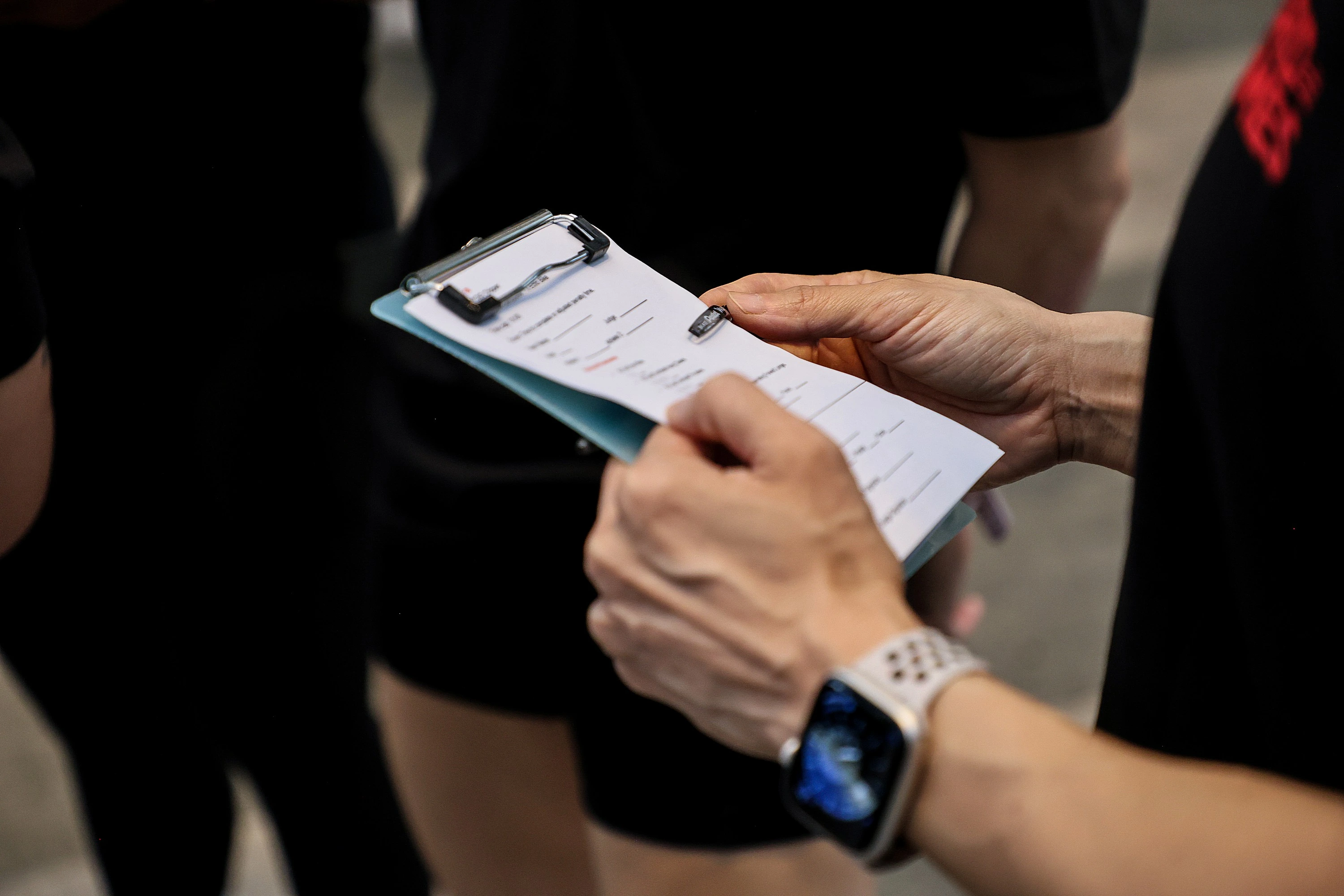 Event coordinator collecting voting cards from attendees at a company function