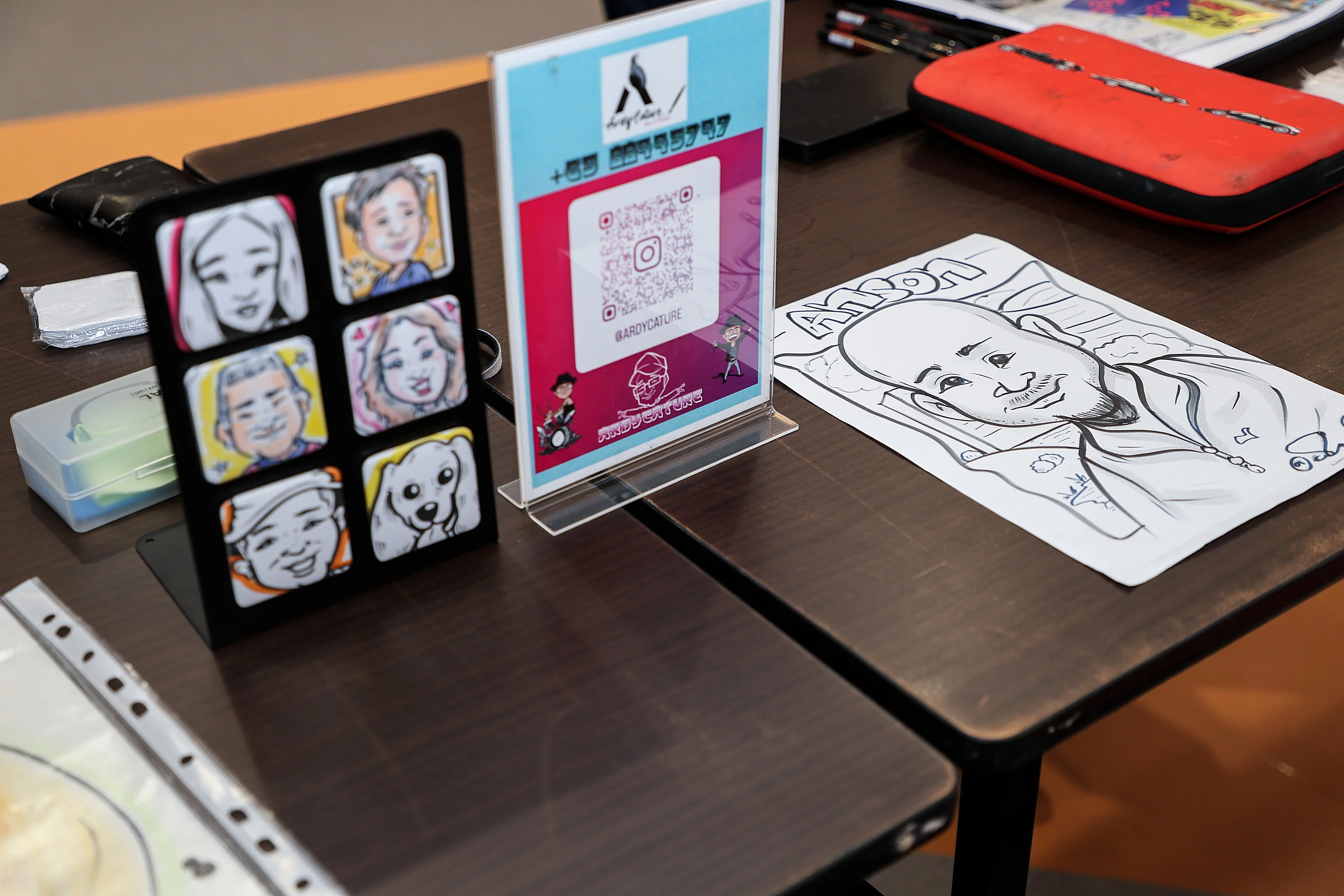 Custom caricatures and QR code display table at a wedding reception