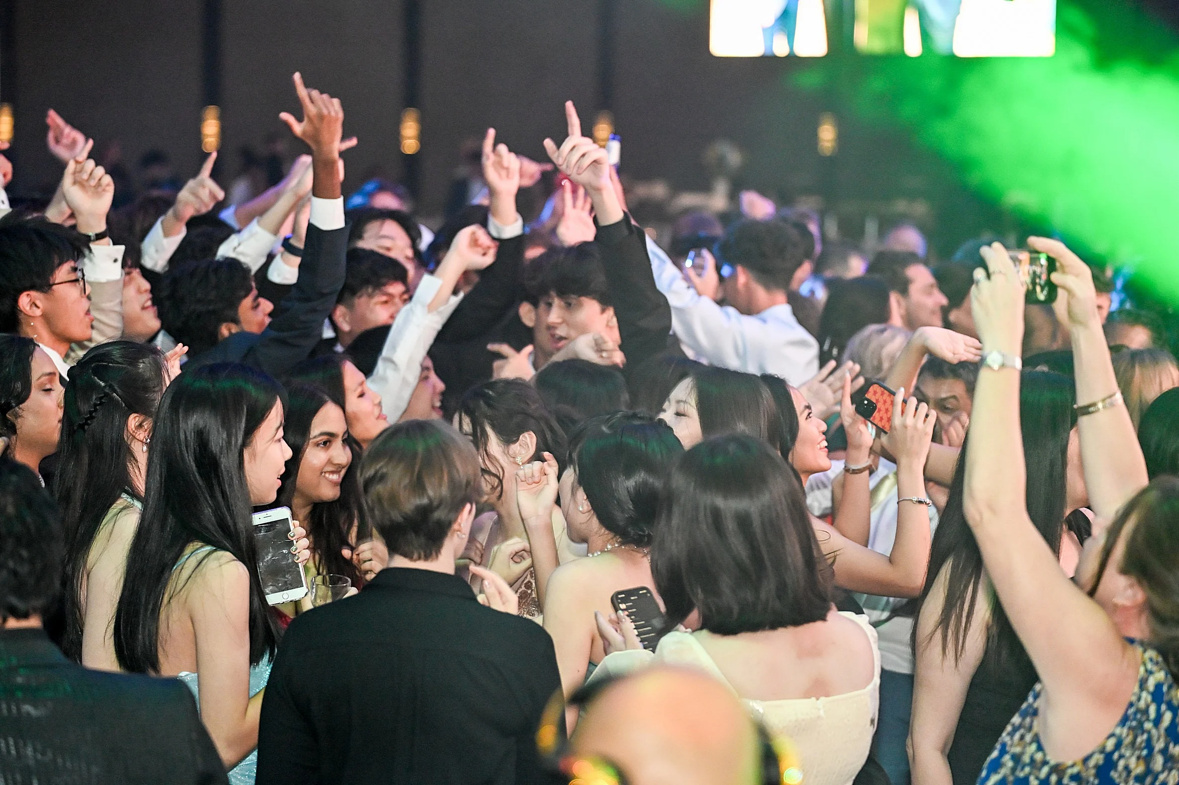 Energetic crowd of wedding guests dancing on the dance floor